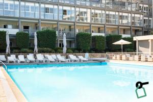 a swimming pool in front of a building at Hotiday Corfu Kanoni in Corfu