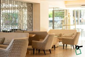 a dining room with chairs and a table at Hotiday Corfu Kanoni in Corfu