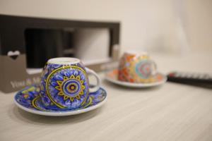 two cups and saucers sitting on a table at Dimora del mare in Agropoli