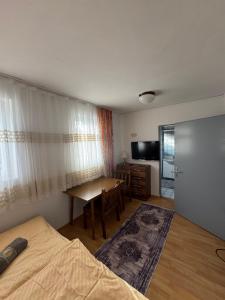 a bedroom with a bed and a table and a desk at Guesthouse Mother in Sielach