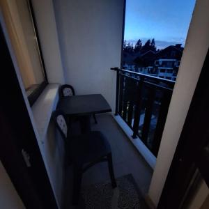 a balcony with a table and chairs and a window at COSY and SPACIOUS APARTMENT C30 in Borovetz in Borovets