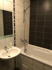 a bathroom with a sink and a tub with a shower at COSY and SPACIOUS APARTMENT C30 in Borovetz in Borovets +7 photos