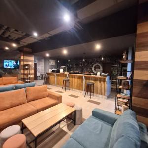 a living room with a couch and a bar at COSY and SPACIOUS APARTMENT C30 in Borovetz in Borovets