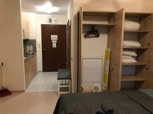 a bedroom with a bed and a kitchen with a closet at COSY and SPACIOUS APARTMENT C30 in Borovetz in Borovets
