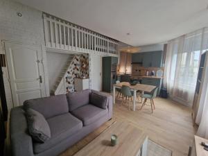 a living room with a couch and a table at Casa Bahia in Berck-sur-Mer