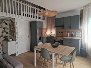 a kitchen and dining room with a table and chairs at Casa Bahia in Berck-sur-Mer