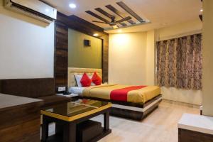a hotel room with a bed and a couch at Abis Inn -Ballygunge in Kolkata +13 photos