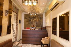 a man sitting at a bar in a restaurant at Abis Inn -Ballygunge in Kolkata