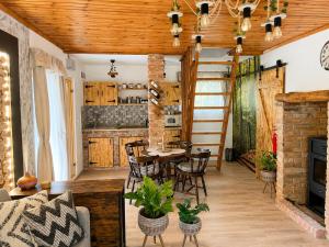 a kitchen and living room with a table and chairs at Cityside Cottage in Eger