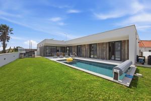 a backyard of a house with a swimming pool at Al Casa Branca in Lourinhã