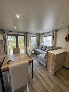 a living room with a table and a couch at Escapade in Lège-Cap-Ferret
