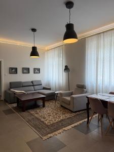 a living room with a couch and a table at Apartament Bankowy in Olecko