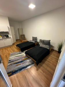 a room with two beds and a rug at Sky Appartment in Koblenz