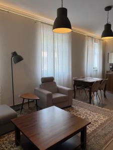 a living room with a couch and a table at Apartament Bankowy in Olecko