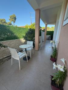 a patio with a table and chairs and plants at GREISON Vacation House in Vlorë