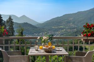 a table with a basket of food on a balcony with mountains at Rota Suites in Rota d'Imagna +55 photos