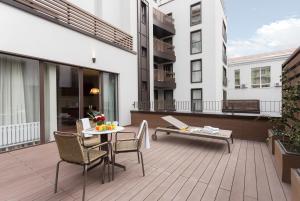 a patio with a table and chairs on a balcony at Il Decameron Luxury Design Hotel in Odesa