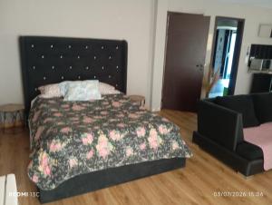 a bedroom with a large bed and a couch at Telhadosolitario in São Pedro da Cova