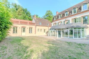 a large house with a yard in front of it at La Demeure des Sources - Iris - Avec climatisation in Bourbon-Lancy