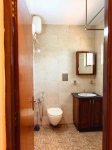 a bathroom with a toilet and a sink at Siolim Serenity in Siolim