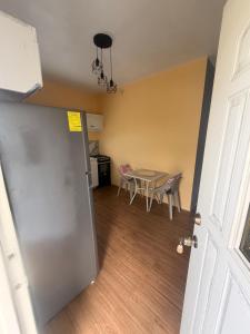 a door leading into a room with a table and a kitchen at Sunfusion apartment & Cottages in Saint Mary +5 photos