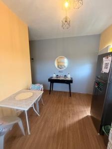 a living room with a table and a refrigerator at Sunfusion apartment & Cottages in Saint Mary