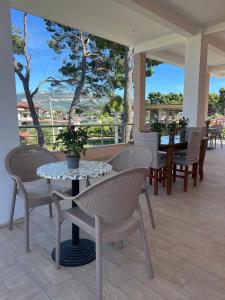 a patio with chairs and a table with a potted plant at GREISON Vacation House in Vlorë