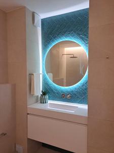 a bathroom with a sink with a mirror at Beachfront 3bdr apt on Marginal Boulevard in São Martinho do Porto +22 photos