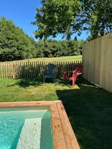 a backyard with a pool and a bench and a fence at Gîte Alice Piscine privée in Hauterives