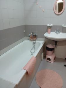 a bathroom with a bath tub and a sink at Kannon 1 5-minute walk to all transport options at the Pragal terminal in Caparica +16 photos