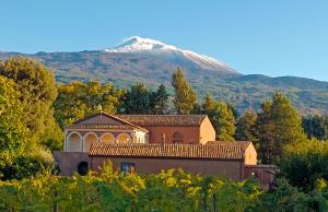 a house with a mountain in the background at CASALE DILETTOSO Etna Relais in Randazzo