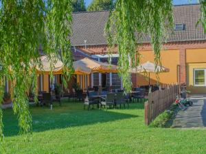 a patio with tables and chairs in front of a building at Die Kulturscheune in Schilde in Schilde