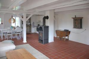 a living room with a stove and a table at Van Gunst Hüs, Alkersum in Alkersum