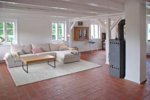 a living room with a couch and a table at Van Gunst Hüs, Alkersum in Alkersum +17 photos