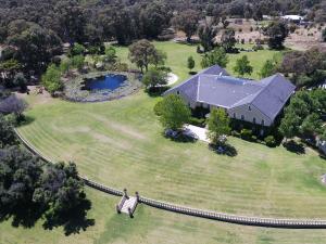 an aerial view of a house with a large yard at Peel Manor House in Karnup