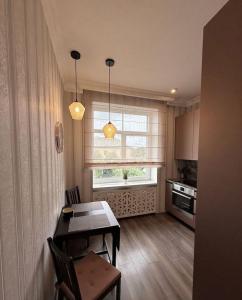 a small kitchen with a table and a window at 2 room central apartment in Jelgava
