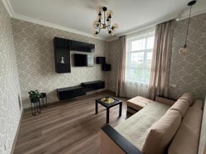 a living room with a couch and a table at 2 room central apartment in Jelgava