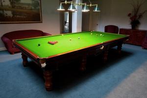 a pool table with balls on it in a room at Peel Manor House in Karnup