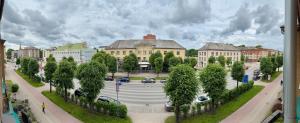 a street in a city with buildings and trees at 2 room central apartment in Jelgava