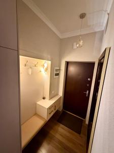 a room with a hallway with a door and a table at 2 room central apartment in Jelgava