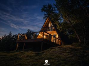 a cabin on top of a hill at night at Rancho Sol Poente - Rancho Queimado - SC in Rancho Queimado