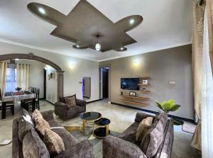 a living room with a couch and a table at Jubilant Experience Homes Arusha in Arusha