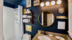 a bathroom with a sink and a mirror at Helltown Hideaway - Private Patio, Walk Anywhere, Free Parking in Provincetown