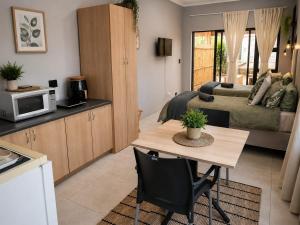 a kitchen and living room with a table and a couch at The Lion's Den in George