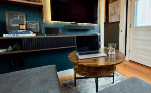 a laptop sitting on a wooden table in a room at Helltown Hideaway - Private Patio, Walk Anywhere, Free Parking in Provincetown +33 photos