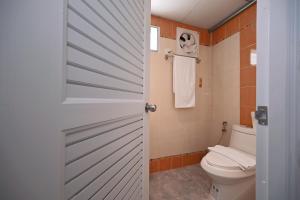 a bathroom with a toilet and a white door at Stay C Hotel in Ban Samet +67 photos