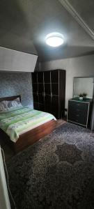 a bedroom with a large bed and a large rug at Квартира у бульвара 1 in Batumi