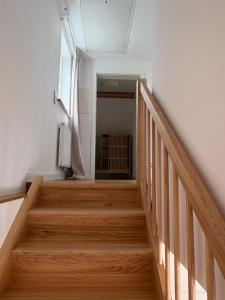 a staircase in a room with wooden floors and a window at An der Obstwiese in Untergut +1 photo