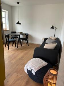 a living room with a couch and a table at An der Obstwiese in Untergut