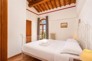 a bedroom with a large white bed in a room at Villa Le Balze Large Private Pool WiFi in Florence +27 photos